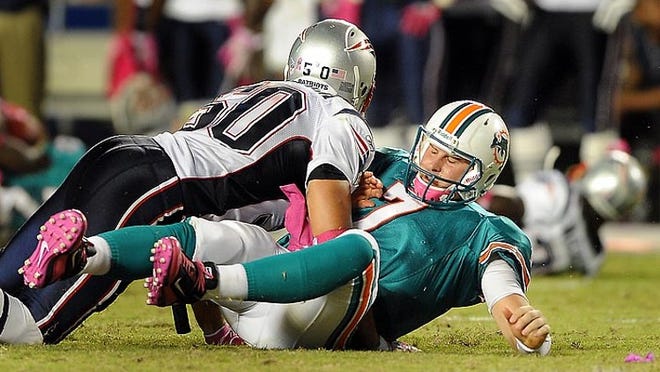 Dolphins quarterback Chad Henne gets knocked down by Patriots linebacker Rob Ninkovich in a 41-14 loss to New England on Oct. 4, 2010.