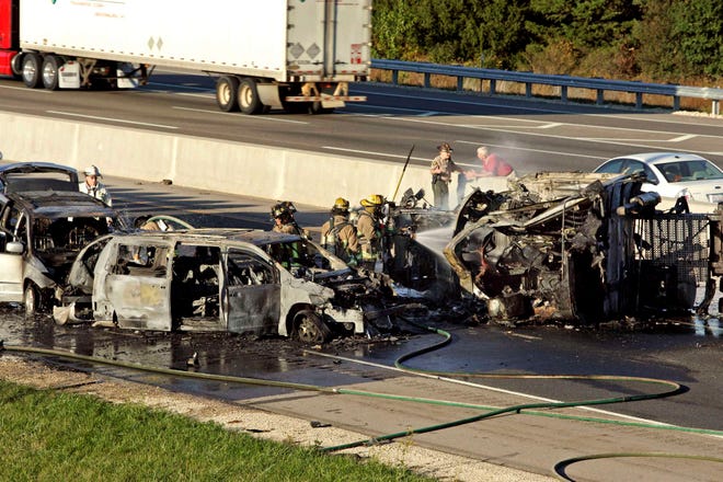 Firefighters put out a fire from a multivehicle accident on Interstate 90 just past the East State Street exit Tuesday, Oct. 5, 2010, in Rockford.