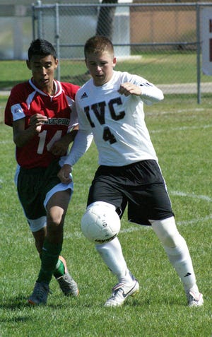Fight to the finish: IVC senior Matt Welch battles for the ball for the Grey Ghosts with a defender from LaSalle-Peru.