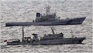 A Japanese Coast Guard vessel and a Chinese fisheries patrol ship, near islands that both countries claim.