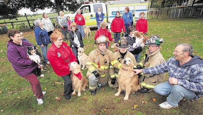 10-4-2010 Doug Coulter a dog trainer and handler, far right, and another trainer donated the money to buy 3 pet oxygen sets for the Mechanicstown Fire Department.