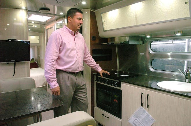 David Traks, general sales manager at Bay State Ford Commercial Truck Center in Stoughton, stands inside the kitchen area of an Airstream trailer. Airstream New England opened Wednesday at the truck center.