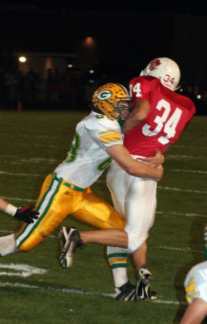 Cole Reiling wraps up the Ottawa ball carrier during conference action in Ottawa Oct. 1.