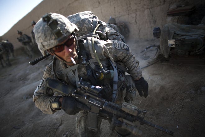U.S. Army Sgt. Bill Myers, of Phoenix, prepares to patrol after a break near Kandahar province, Afghanistan Thursday.