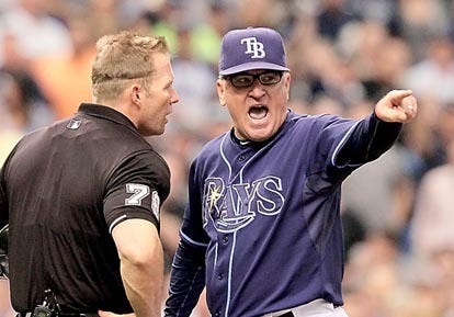 Tampa Bay Rays manager Joe Maddon, right, argues with home plate umpire Jim Wolf after Maddon challenged a check swing call on Texas Rangers batter Michael Young during the fifth inning of Game 2 of baseball's American League Division Series, Thursday, Oct. 7, 2010 in St. Petersburg. Young hit a three-run home run on the next pitch. Maddon was ejected for arguing. (AP Photo/Chris O'Meara)