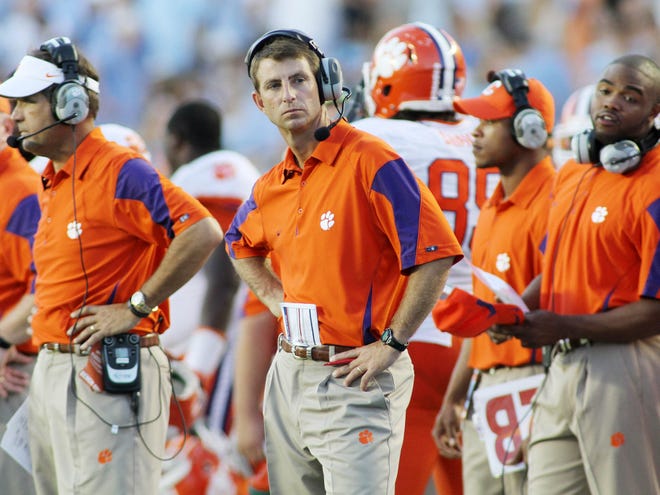 Clemson head football coach Dabo Swinney, center, apologized after Saturday’s 21-16 loss to North Carolina at Chapel Hill, N.C.