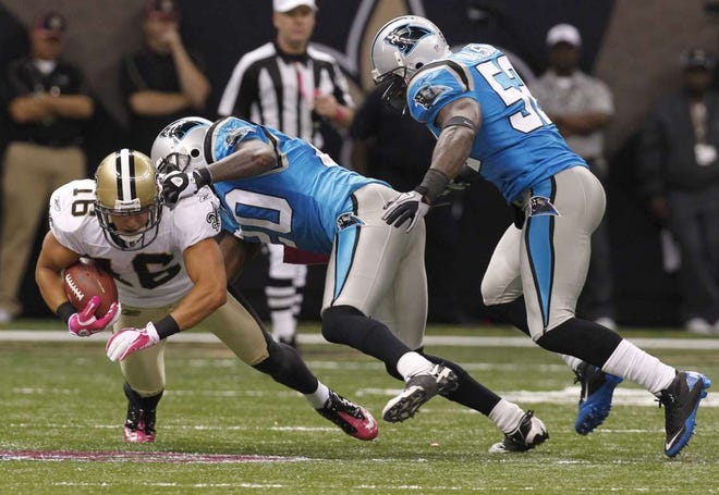 New Orleans Saints wide receiver Lance Moore is tackled by Carolina Panthers cornerback Chris Gamble (center) and linebacker Jon Beason on Sunday, Oct. 3, 2010, at the Louisiana Superdome in New Orleans, La. The Saints won 16-14.
