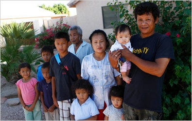 Hai Doo, right, a refugee from Myanmar shown with his family, bought his house in Phoenix with the help of large grants. Arizona accepts more refugees per capita than almost any other state and treats them well.