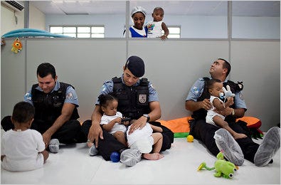 Brazilian police officers with a new community relations unit visited a day care center in the City of God slum in Rio de Janeiro.