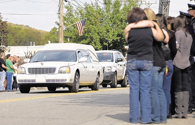 Friends and neighbors console each other as a motorcade for Marine Lance Cpl. Scott Lynch of Greenwood Lake makes its way down Windermere Avenue on Monday. Lynch, 22, died while conducting a combat operation in Afghanistan. See more photos at recordonline.com.