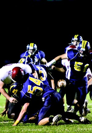 The football flies loose for the Warriors with G-A’s Josh Hornestein (54) on the pile. Denton Ensminger (51) aims for the recovery. (Bob Stoler Photos)