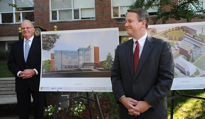 Lt. Gov. Timothy Murray, right, and Framingham State University president Timothy Flanagan stand next to plans for the new Science Center in Hemenway Hall during a ceremony in front of the future site Tuesday.