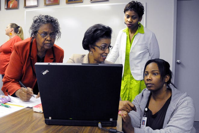 Debra Keels, (second from left) a school system Title I specialist, talks with Title I Parents Advisory Council members (from left) Iva Smith, Sharon Hodges and Stacy Leonard, who are trying to increase parental involvement in schools.