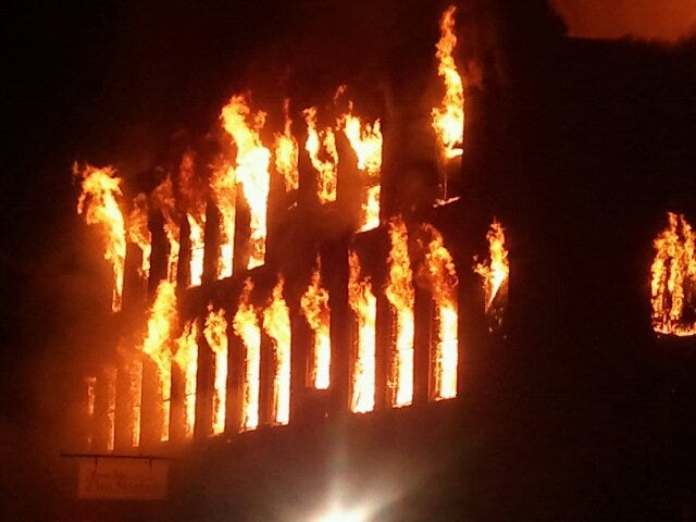 Flames burst through the windows of Garver's Flea Market building at Strasburg on Wednesday night.