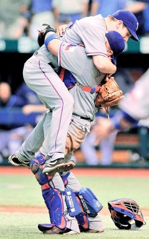 Texas Rangers catcher Bengie Molina, right, hugs pitcher Cliff Lee after beating Tampa Bay on Tuesday. The Associated Press