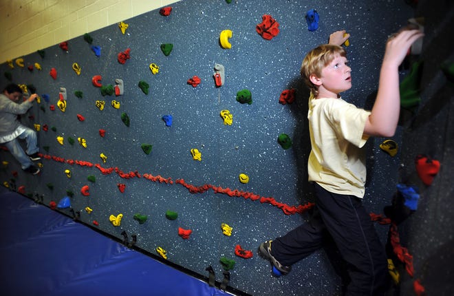 Fifth-grader Ben Westervelt takes the first climb on Stapleton Elementary School's new rock wall.