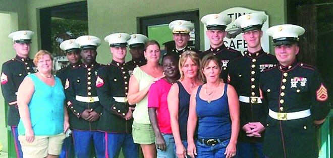 Bravo Company 4th Assault Amphibian Battalion, 4th Marine Division, Jacksonville, pose with the Hastings Cafe staff Laura Friday, Debbie Andrade, Diane Clark, Deb Tice and Michelle Hagan. By MALEA GUIRIBA, Special to The Record