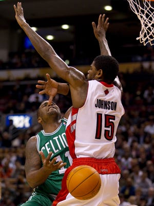 Boston's Glen Davis loses control of the ball as he runs into Toronto's Amir Johnson during NBA preseason action in Toronto on Friday, Oct. 15, 2010.