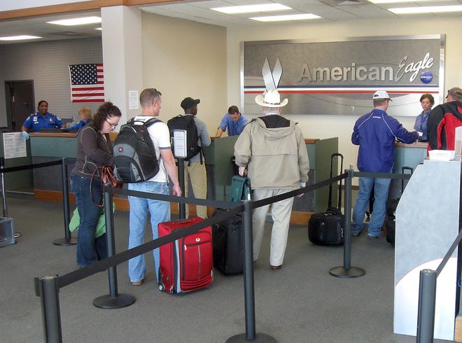 Students, soldiers and business travelers queue up daily at the American Eagle check-in counter at Manhattan Regional Airport. Three flights daily to Dallas-Fort Worth are filled to more than 80 percent of capacity, enough that American will add a Chicago flight in November.