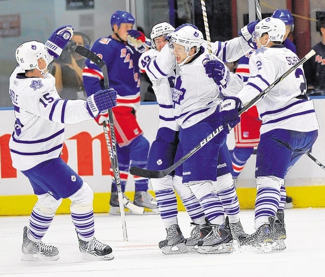 Maple Leafs' Phil Kessel, center, celebrates his goal with teammates Tomas Kaberle, Tyler Bozak and Luke Schenn, left to right, as several Rangers look on during the second period of a game Friday in New York. The Maple Leafs won, 4-3, in overtime.
