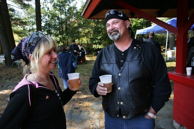 Terri Kurgan, left, of Leominster and Kevin Casey, of Framingham, enjoy a beer after the Heather Alleyne Texas Hold 'Em Poker Run yesterday at the Riverside Gun Club in Hudson.