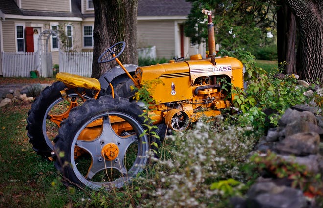 A farm tractor sits idle off West Elm Street in Pembroke.