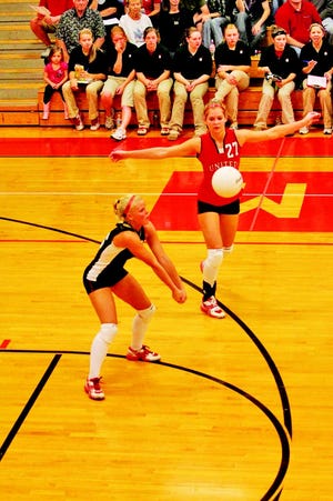 Katie Kaywood bumps a pass forward against West Central with Gina Long preparing to jump for a kill attempt.