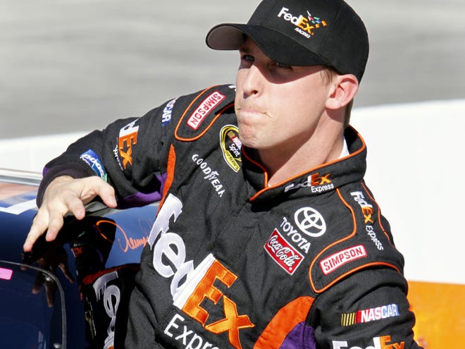 Denny Hamlin gets out of his car after winning the pole Friday during qualifying for Sunday’s Tums Fast Relief 500 Sprint Cup race at the Martinsville Speedway in Martinsville, Va.