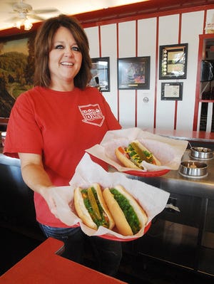 Jodi Miller, co-owner of Union Dairy, serves up hot dogs Thursday at the Freeport mainstay. Oct. 23 is Customer Appreciation Day.
