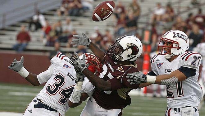 FAU defensive backs Keith Reaser (34) and Marcus Bartels (27) try to stop Louisiana-Monroe wide receiver Luther Ambrose (22) from catching a pass during Monroe's 20-17 win on Saturday, Oct. 9, 2010.