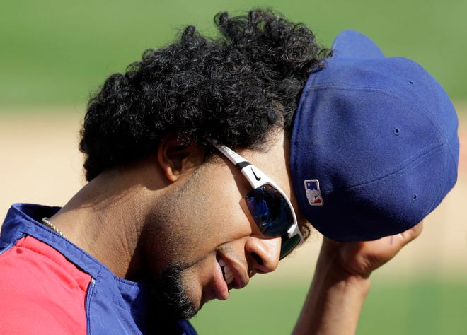 Texas Rangers shortstop Elvis Andrus takes off his hat Thursday during practice for Game 6 of the American League Championship Series against the New York Yankees. AP photo