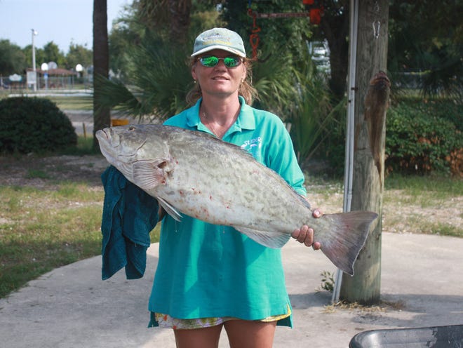 Michelle Miller poses with a 19.7-pound grouper caught last month.