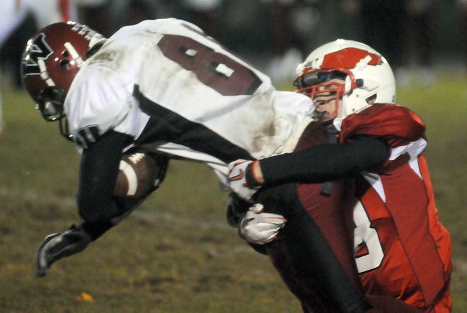 Milford's Thomas Hytholt wraps up Westborough's Trevor Laham during high school football, Friday in Milford.
