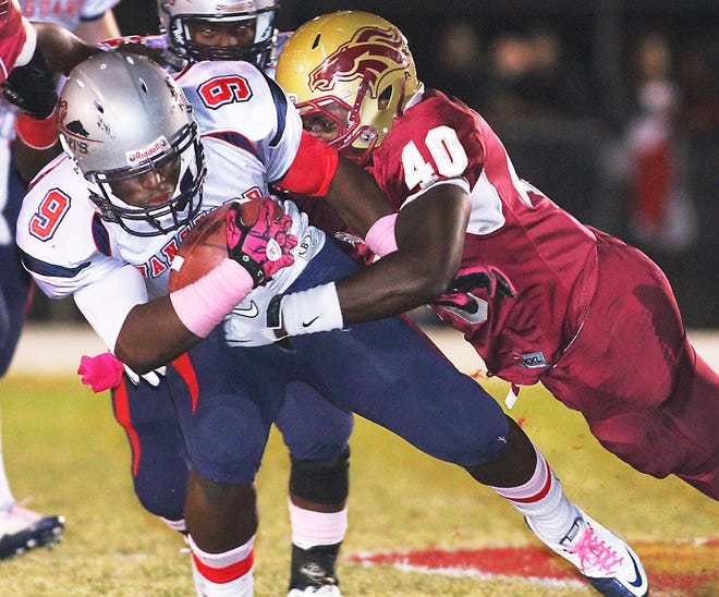 Vanguard's Re'shard Munnerlyn gets tackled by North Marion's Devon Brant on Friday night in Sparr.