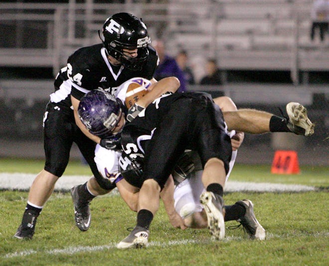 Perry's Tony Magnacca, left, and Josiah Dehnke team up for the tackle of Jackson's Spencer Scheetz on Friday night.