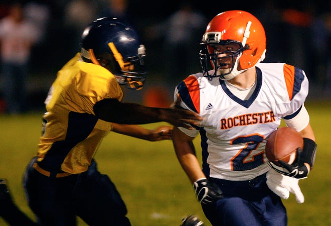 Rockets receiver Blake Gand evades a Spartans defender. On the next play he scored his team's fifth touchdown of the night.