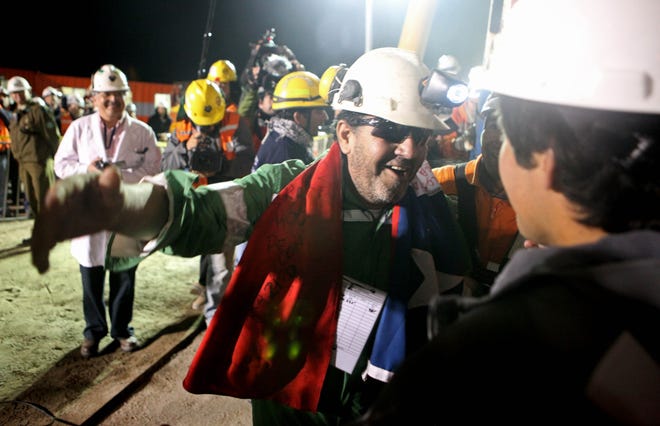 Luis Urzua reaches out to hug people after being freed Oct. 13 from the collapsed San Jose gold and copper mine near Copiapo, Chile. He had been trapped with 32 other miners for more than two months.
