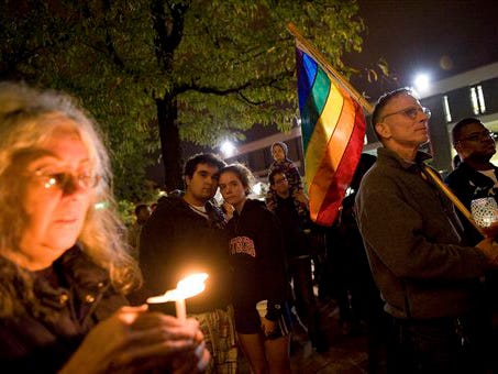 In this Oct. 3, 2010 file photo, people participate in a candlelight vigil for Rutgers University freshman Tyler Clementi at Brower Commons on the Rutgers campus in New Brunswick, N.J. New Jersey lawmakers introduced a bill Monday Oct. 25, 2010 to toughen the state's anti-bullying laws after Clementi's widely publicized suicide. Clementi committed suicide last month after authorities say his roommate secretly webcast his tryst with a man. (AP Photo/Reena Rose Sibayan, File)