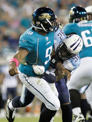 Jaguars quarterback David Garrard (left) is hit by the Titans' Will Witherspoon on Oct. 18 at EverBank Field.