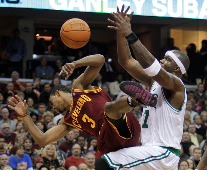 Celtics forward Jermaine O'Neal, right, fouls Cavaliers guard Ramon Sessions (3) during the fourth quarter of Wednesday's game in Cleveland.
