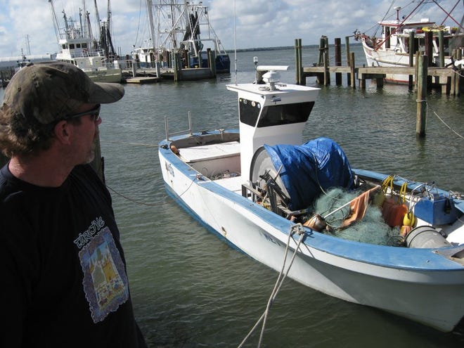 Mike Galvan, a veteran fisherman based at Safe Harbor Seafood in Mayport, looks out over the docks where he'd often see his friend Bruce Christ, who died in a shrimping boat accident off of Amelia Island Monday.