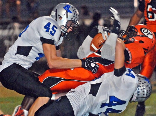 Orange Park's Terrance Plummer, gets stopped by Bartram Trail's James Mancino and Jacob Larson.