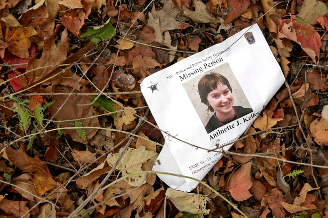 A missing person flier lies on the ground Thursday, Oct. 28, 2010, at Northern Illinois University in DeKalb.