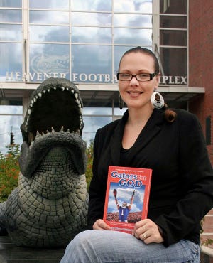 Suzy Richardson with a copy of her new book, “Gators for God,” which profiles 12 University of Florida football players who share their stories of faith.