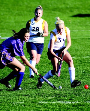 G-A’s Zoe Huston works the ball as Rachel Monninger provides back up during middle school varsity field hockey action last week.