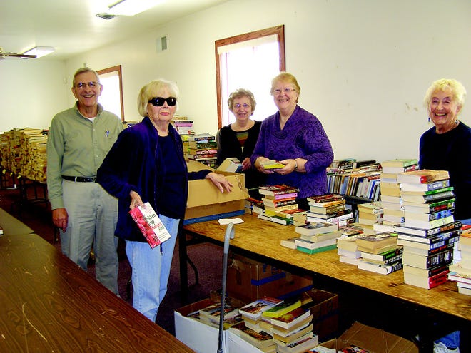 Paul Freeman, Merna Slabik, Shirley Freeman, Minerva Trimmer and Evelyn Pensinger stand among 8-9,000 used books for sale at Trinity Lutheran Church this weekend. The materials were collected from points in Greencastle, Waynesboro and Chambersburg and proceeds will benefit Habitat for Humanity of Franklin County, food banks and other local charities. The sale at 1186 Jason Drive will be conducted Thursday 10 a.m. to 7 p.m., Friday 10 a.m. to 6 p.m. and Saturday 8:30 a.m. to noon. Saturday is ‘bag day’ with each bag $6 or buy three bags, get one free.