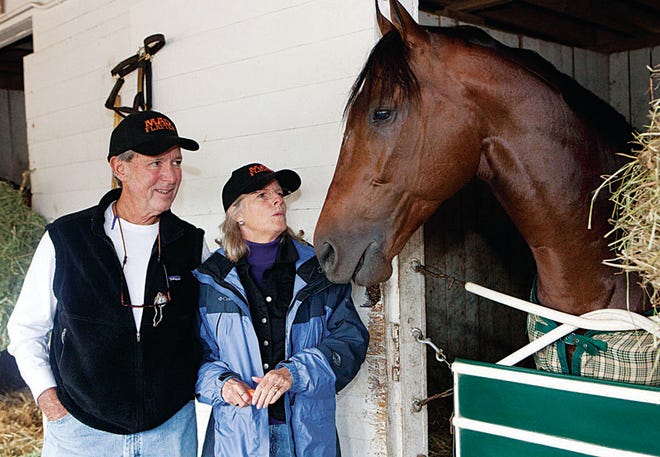 Bonnie Heath III and his wife Kim feed their 2010 Breeders' Cup horse, Mad Flatter, carrots at barn 17 at Churchill Downs.