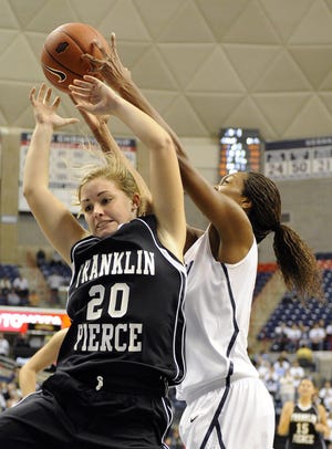 Connecticut's Michala Johnson, right, grabs a rebound from Franklin Pierce's Brittany Martelle during the second half of their exhibition NCAA women's college basketball game in Storrs, Conn., on Thursday, Nov. 4, 2010. Connecticut won the game 112-41.
