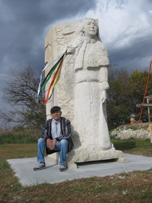 Artist Jim Wahwassuck, who lives at the Prairie Band Potawatomi reservation near Mayetta, sits on the base of “Tonantzin,” a 17-foot-tall sculpture of a Mascouten “noble lady of state” he created to commemorate the 1830 Indian Removal Act, the forced relocation of Indians to lands east of the Mississippi River, and the Potawatomi Trail of Death, the forced removal of Potawatomi Indians from north-central Indiana to eastern Kansas in 1838. Once completed, sculpture will be installed at the reservation’s Elder Center.