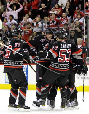 Carolina Hurricanes' Erik Cole (26) and Jeff Skinner (53) celebrate a goal by teammate Eric Staal, center, during the second period of an NHL hockey game against the Florida Panthers in Raleigh, N.C., Saturday, Nov. 6, 2010.